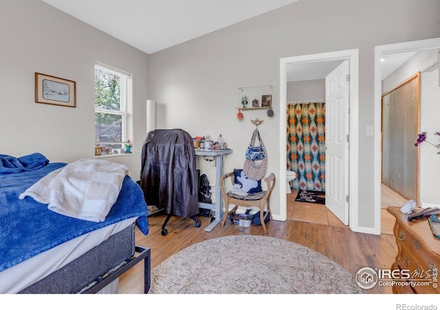 3100 Denton Ave, Boulder, CO 80303 - bedroom featuring wood finished floors, connected bathroom, and baseboards