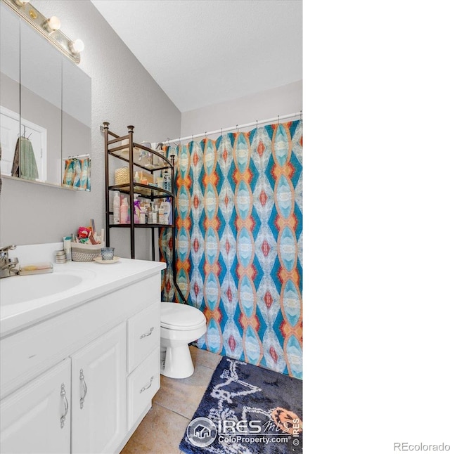 3100 Denton Ave, Boulder, CO 80303 - full bath featuring toilet, vanity, a shower with curtain, and tile patterned flooring