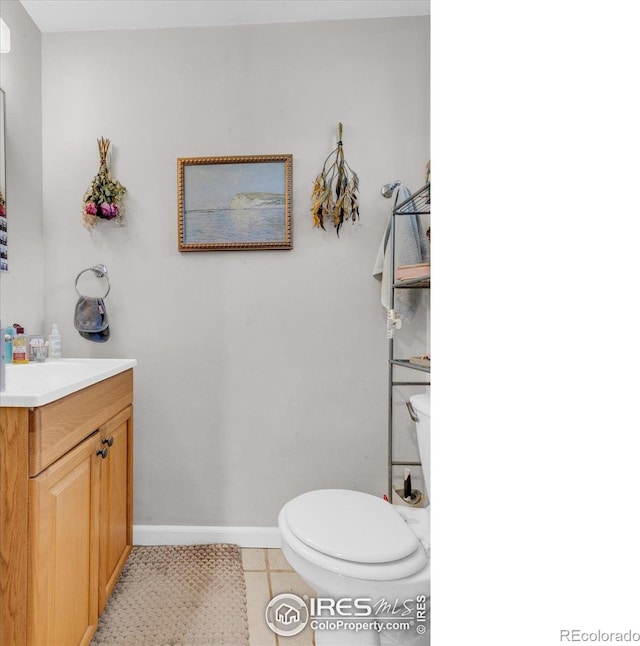 3100 Denton Ave, Boulder, CO 80303 - half bathroom with toilet, vanity, baseboards, and tile patterned flooring