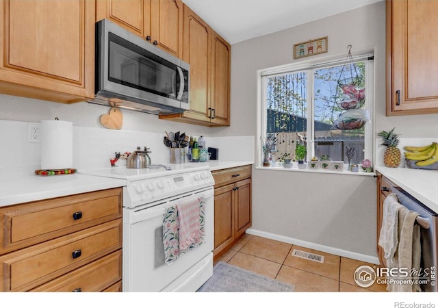 3100 Denton Ave, Boulder, CO 80303 - kitchen with appliances with stainless steel finishes, light countertops, baseboards, and light tile patterned floors