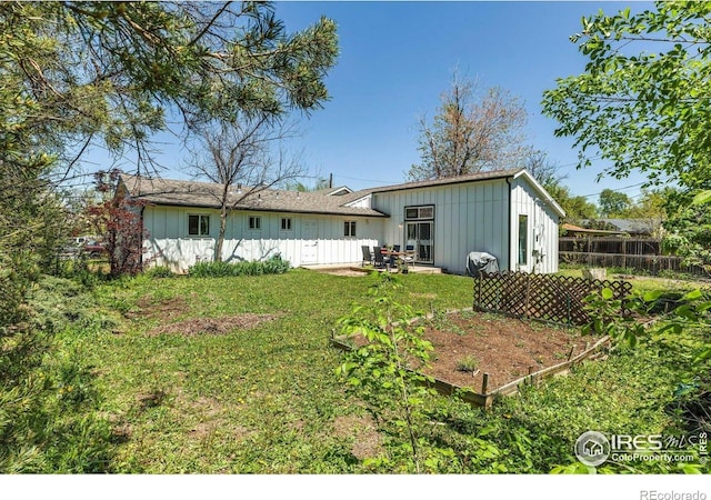 3100 Denton Ave, Boulder, CO 80303 - rear view of property with board and batten siding and a vegetable garden