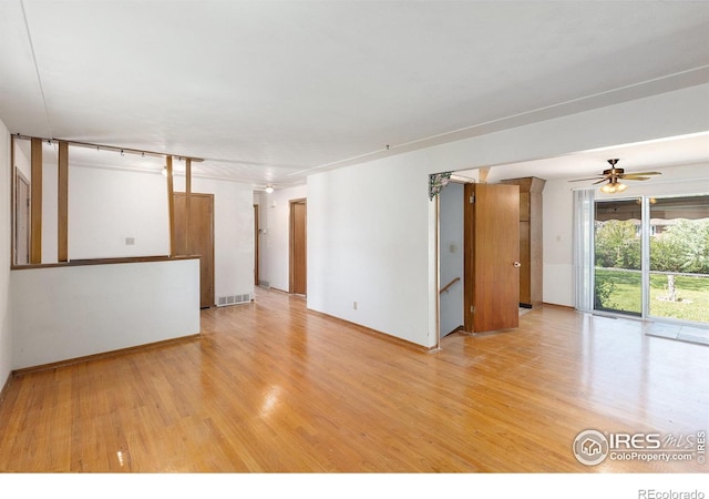 1207 S Tyler Ave, Loveland, CO 80537 - unfurnished living room featuring light wood-style floors, a ceiling fan, and baseboards