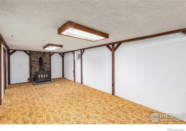 1207 S Tyler Ave, Loveland, CO 80537 - additional living space featuring a wood stove and a textured ceiling