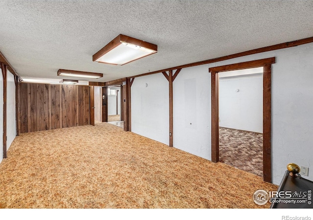 1207 S Tyler Ave, Loveland, CO 80537 - additional living space featuring a textured ceiling, carpet flooring, and wood walls