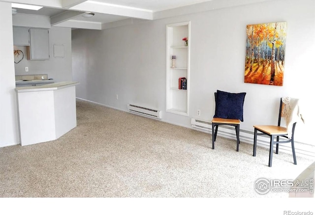 unfurnished room featuring a baseboard radiator, carpet flooring, and built in features