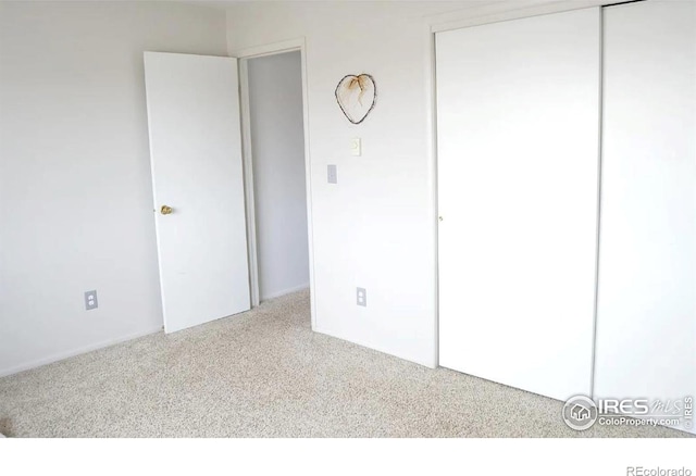 unfurnished bedroom featuring a closet and carpet