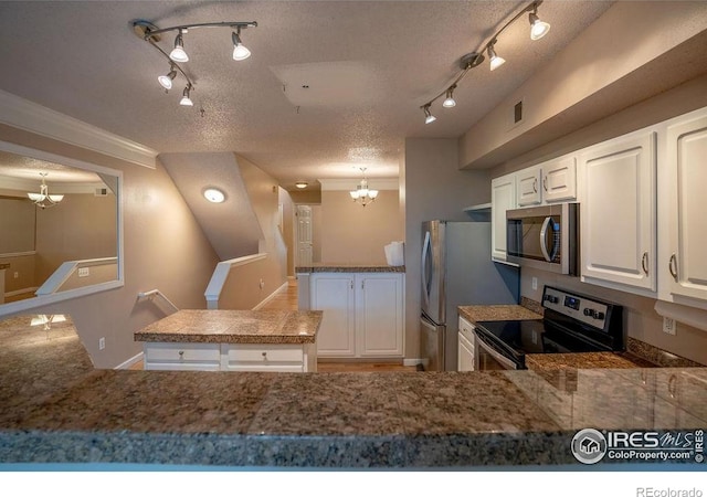 2092 N Concord Ln, Superior, CO 80027 - kitchen featuring appliances with stainless steel finishes, a chandelier, track lighting, a peninsula, and white cabinets