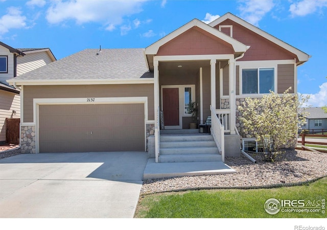 view of front of home featuring an attached garage, stone siding, concrete driveway, and roof with shingles