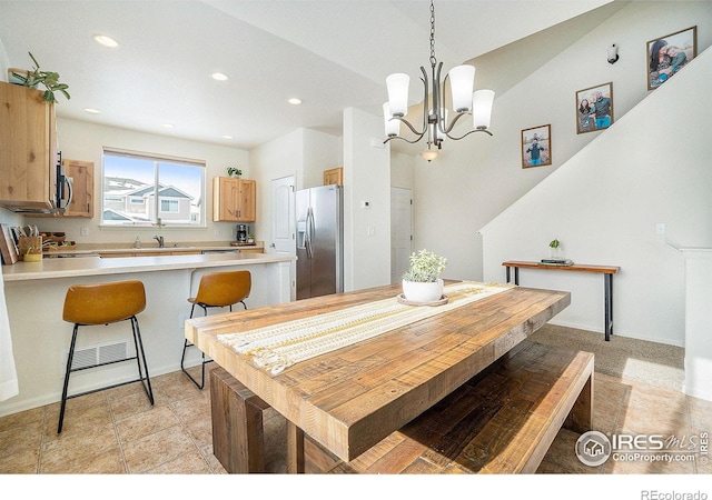 dining area featuring recessed lighting and a chandelier