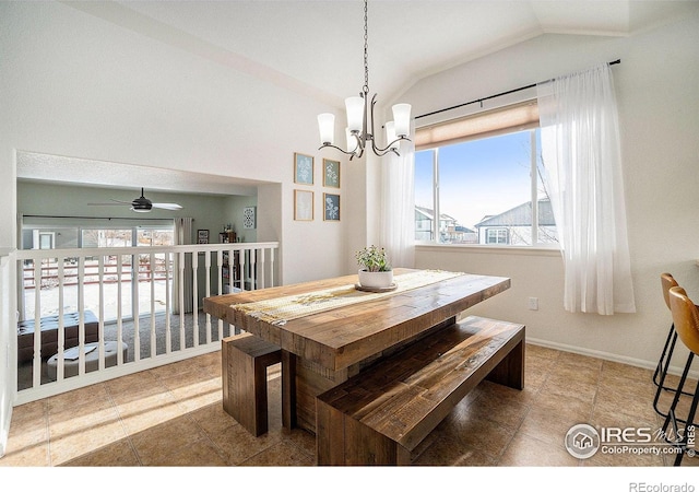 dining room with vaulted ceiling, a chandelier, ceiling fan, and baseboards