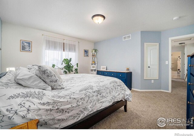 carpeted bedroom featuring baseboards