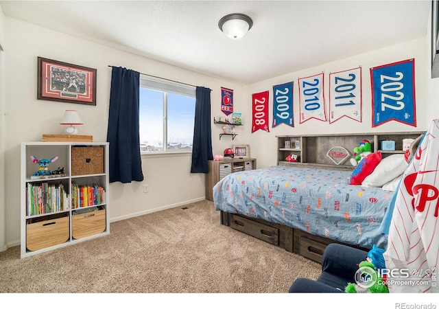 bedroom featuring carpet flooring and baseboards