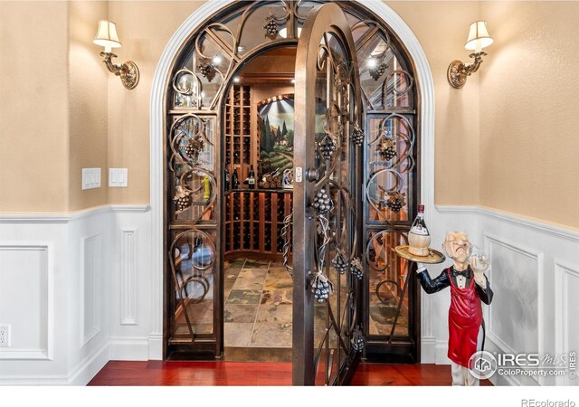 1030 Harbor Walk Ct, Fort Collins, CO 80525 - wine area featuring wainscoting and a decorative wall
