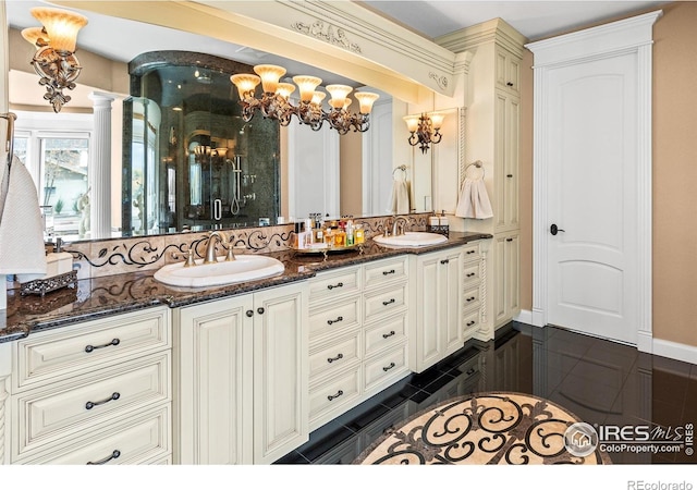 1030 Harbor Walk Ct, Fort Collins, CO 80525 - bathroom featuring double vanity, a chandelier, a shower stall, and ornate columns