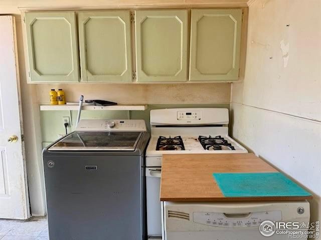 230 W Chase St, Haxtun, CO 80731 - kitchen featuring washer / clothes dryer, white gas range, cream cabinets, and light countertops