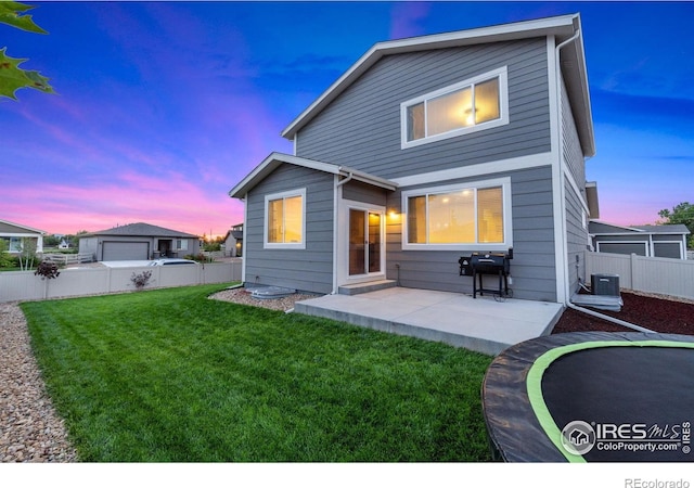 3751 Beech Tree St, Wellington, CO 80549 - back of property at dusk with a patio