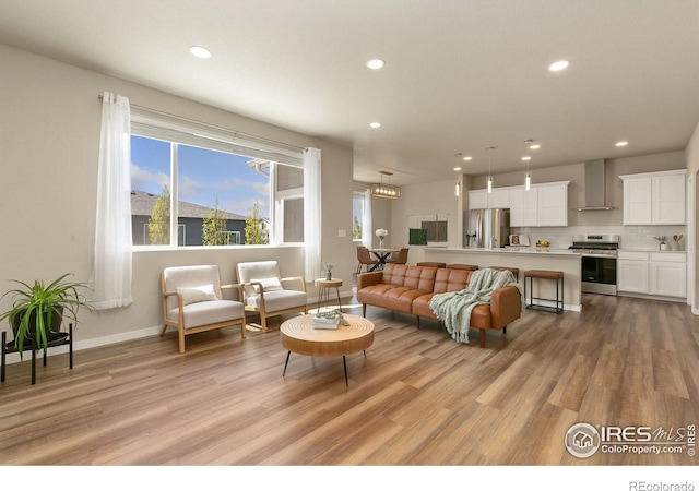 3751 Beech Tree St, Wellington, CO 80549 - living room featuring recessed lighting, light wood finished floors, and baseboards