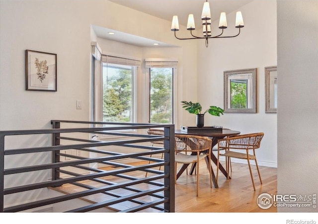 7726 Kit Fox Dr, Wellington, CO 80549 - dining space featuring light wood finished floors, a chandelier, and baseboards