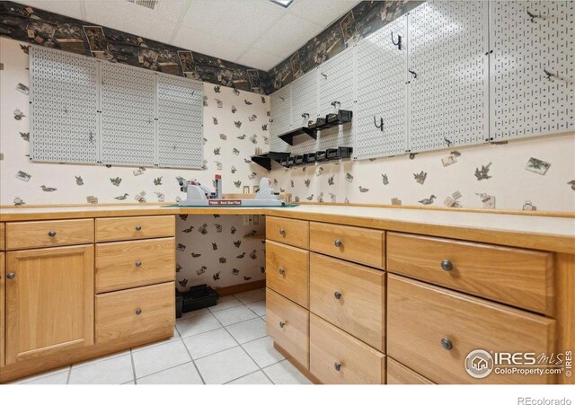 7726 Kit Fox Dr, Wellington, CO 80549 - kitchen with wallpapered walls, light tile patterned floors, and light countertops