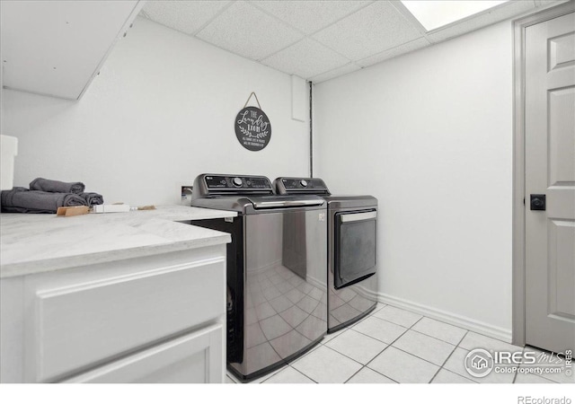 7726 Kit Fox Dr, Wellington, CO 80549 - laundry area featuring washing machine and clothes dryer, light tile patterned floors, and baseboards