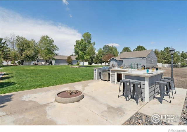 7726 Kit Fox Dr, Wellington, CO 80549 - view of patio featuring a grill and an outdoor kitchen