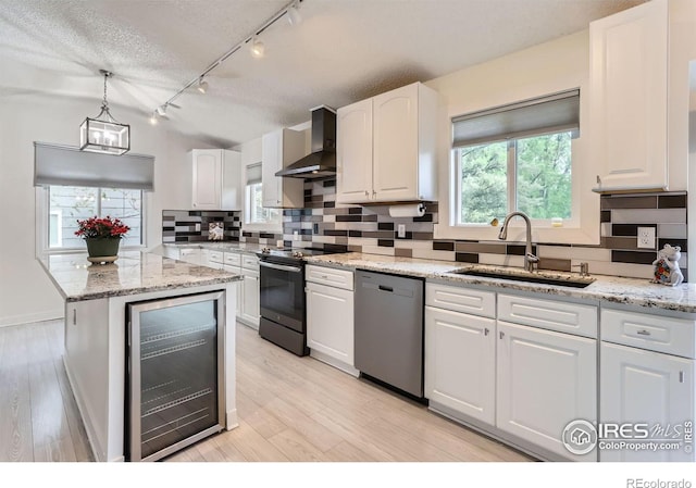 kitchen featuring beverage cooler, wall chimney exhaust hood, electric stove, dishwasher, and a sink