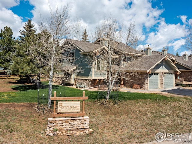 865 Crabapple Ln, Estes Park, CO 80517 - craftsman inspired home featuring a front lawn, an attached garage, asphalt driveway, and a chimney