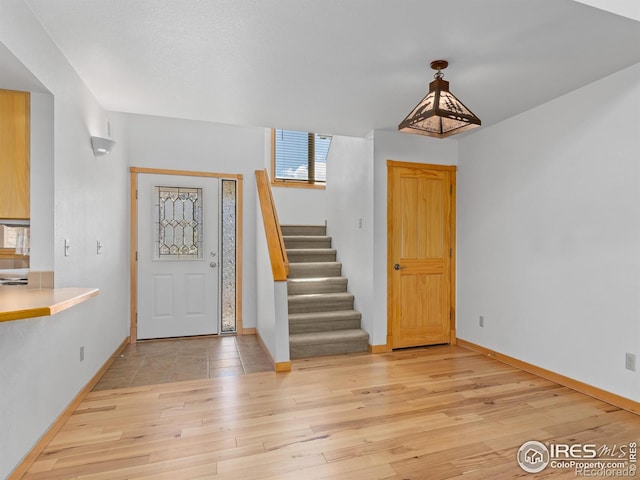 865 Crabapple Ln, Estes Park, CO 80517 - entryway with light wood finished floors, stairs, and baseboards
