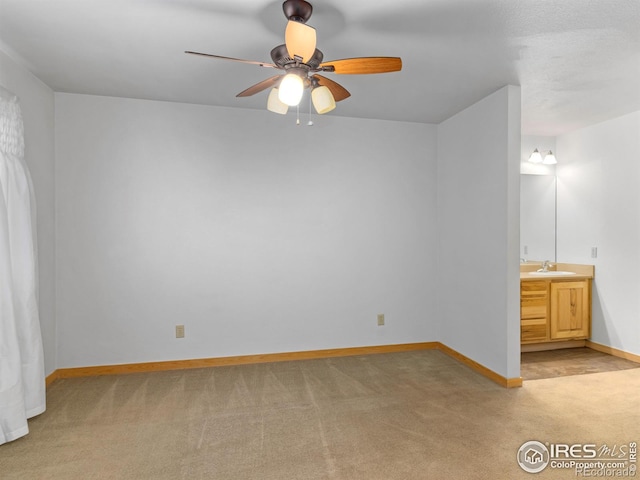 865 Crabapple Ln, Estes Park, CO 80517 - unfurnished bedroom with light carpet, a sink, baseboards, connected bathroom, and ceiling fan