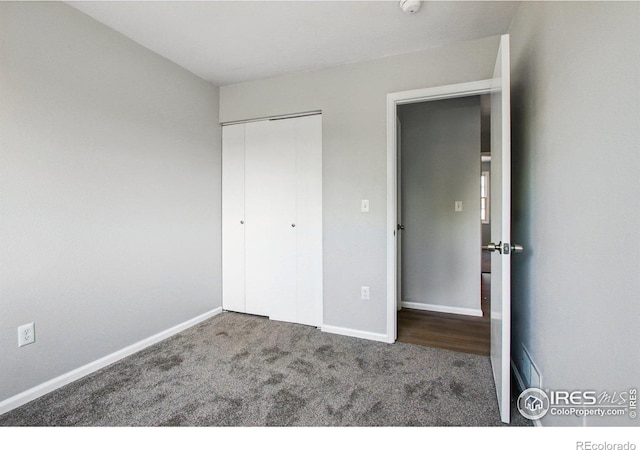 2136 3rd St SW Unit 3, Loveland, CO 80537 - unfurnished bedroom featuring carpet flooring, a closet, and baseboards