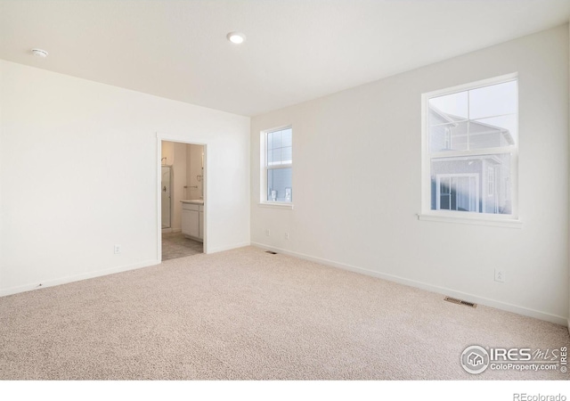 empty room with carpet floors and baseboards
