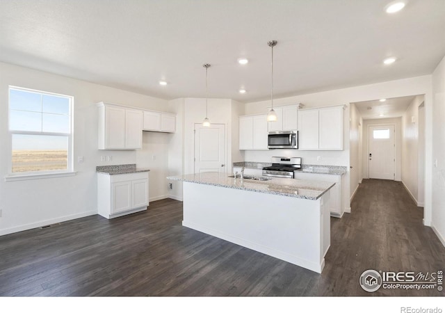 kitchen featuring appliances with stainless steel finishes, dark wood-style floors, recessed lighting, white cabinetry, and healthy amount of natural light