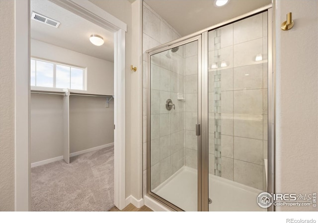 4532 Big Horn Pkwy, Johnstown, CO 80534 - bathroom featuring a shower stall, baseboards, and a walk in closet