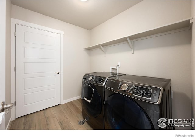 4532 Big Horn Pkwy, Johnstown, CO 80534 - laundry room with separate washer and dryer, wood finished floors, and baseboards