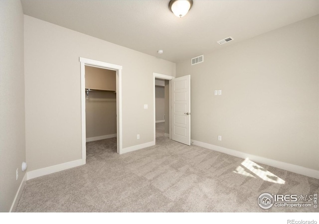 4532 Big Horn Pkwy, Johnstown, CO 80534 - unfurnished bedroom featuring carpet flooring, a walk in closet, baseboards, and a closet