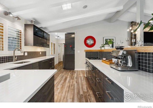2001 James Dr, Loveland, CO 80538 - kitchen featuring a sink, backsplash, light countertops, and light wood-type flooring