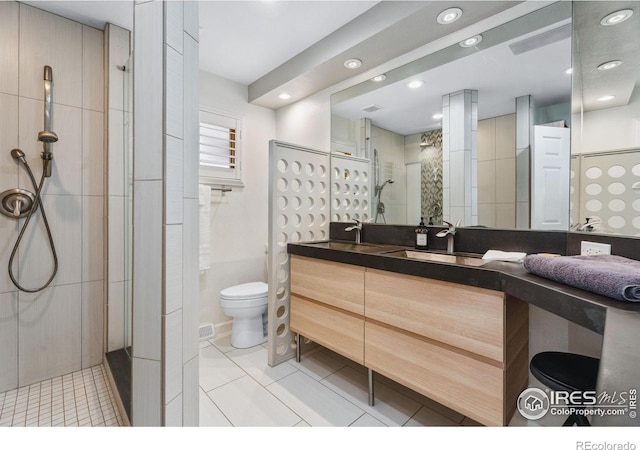 2001 James Dr, Loveland, CO 80538 - full bath with walk in shower, toilet, vanity, recessed lighting, and tile patterned floors