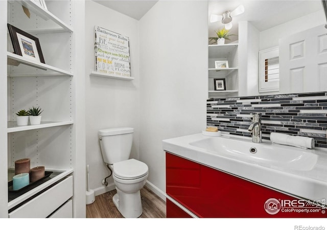 2001 James Dr, Loveland, CO 80538 - bathroom with wood finished floors, toilet, tasteful backsplash, baseboards, and vanity