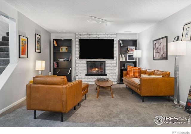 2001 James Dr, Loveland, CO 80538 - carpeted living room with stairs, a textured ceiling, a brick fireplace, built in shelves, and baseboards