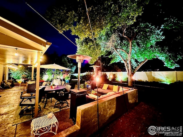 2001 James Dr, Loveland, CO 80538 - patio at night featuring an outdoor hangout area and fence