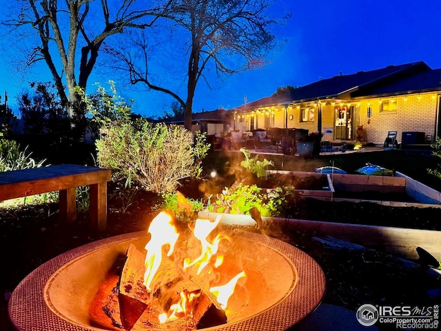 2001 James Dr, Loveland, CO 80538 - yard at twilight with an outdoor fire pit