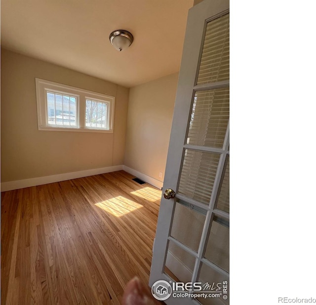 1219 16th St, Greeley, CO 80631 - unfurnished room featuring baseboards and wood finished floors