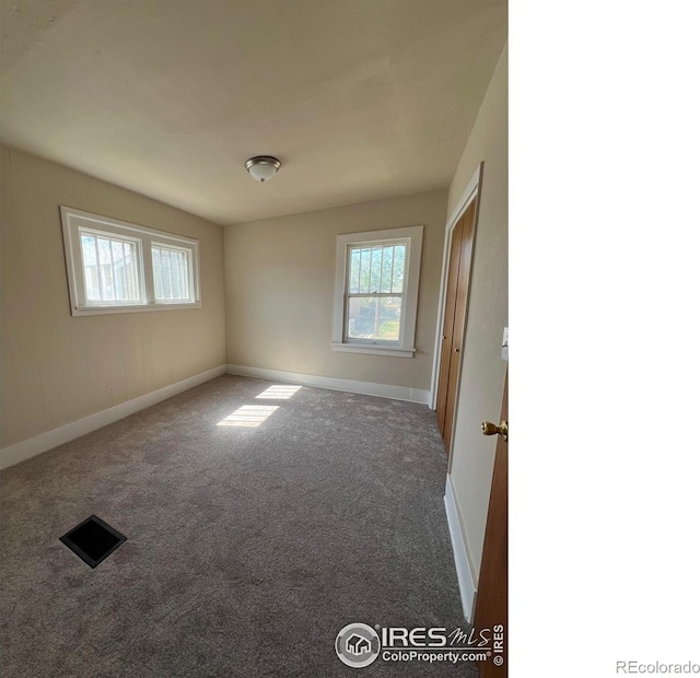 1219 16th St, Greeley, CO 80631 - spare room featuring carpet floors and baseboards