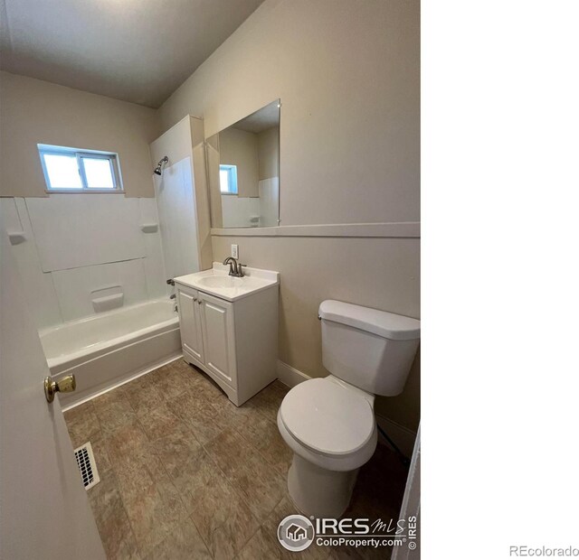 1219 16th St, Greeley, CO 80631 - bathroom featuring toilet, vanity, and bathtub / shower combination