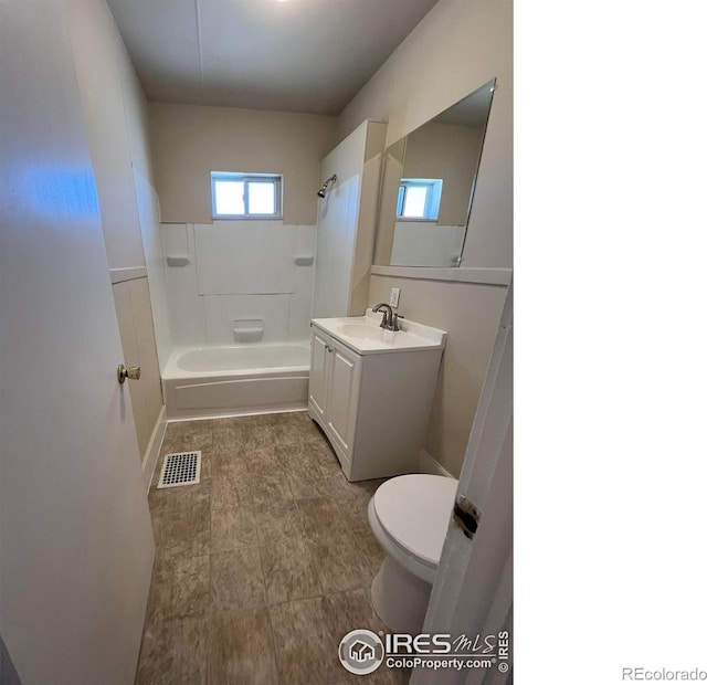 1219 16th St, Greeley, CO 80631 - full bathroom featuring toilet, vanity,  shower combination, and baseboards