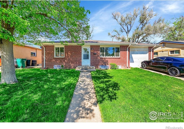 ranch-style home with an attached garage, brick siding, a front lawn, and driveway