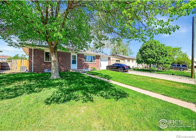 single story home featuring a garage, brick siding, driveway, and central AC unit