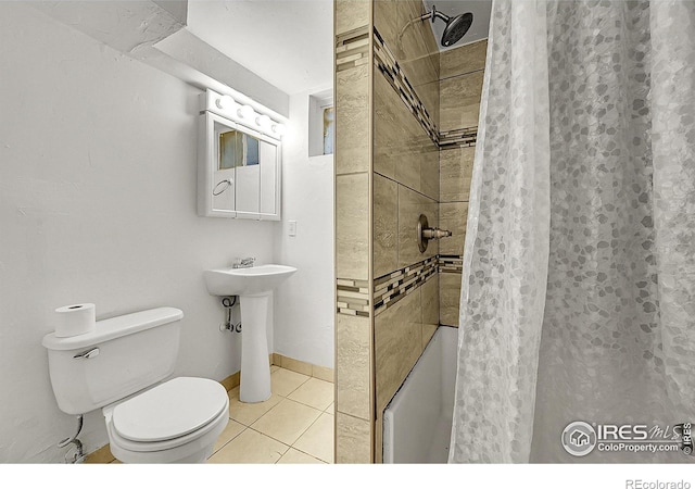 bathroom featuring a stall shower, tile patterned flooring, and toilet