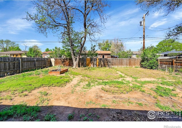 fenced backyard with a garden
