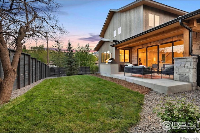 rear view of property featuring an outdoor living space and a patio area